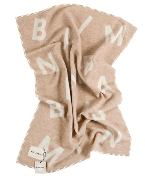 Alphabet Merino Biniblanket – Crib blanket – BINIBAMBA: blanket loosely draped on a light background.