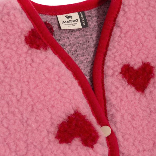 Alwero X Salty – Lulu Baby Vest – Wool: detail of the hearts, button, and trim of the vest.