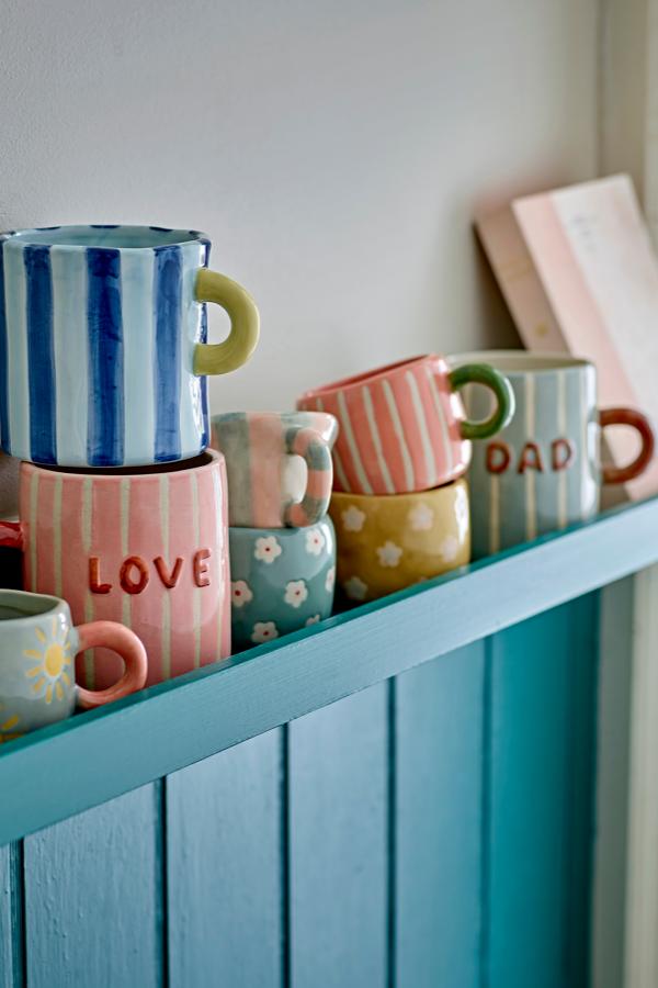 Cherish Mug Blue – Hand-painted ceramic mug with Dad – Bloomingville: several colorful mugs on a cabinet.