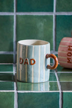 Cherish Mug Blue – Hand-painted ceramic mug with Dad – Bloomingville: blue Dad mug on a countertop.