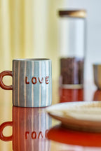 Cherish Mug Blue – Hand-painted ceramic mug with Dad – Bloomingville: blue mug on a table with the word Love.